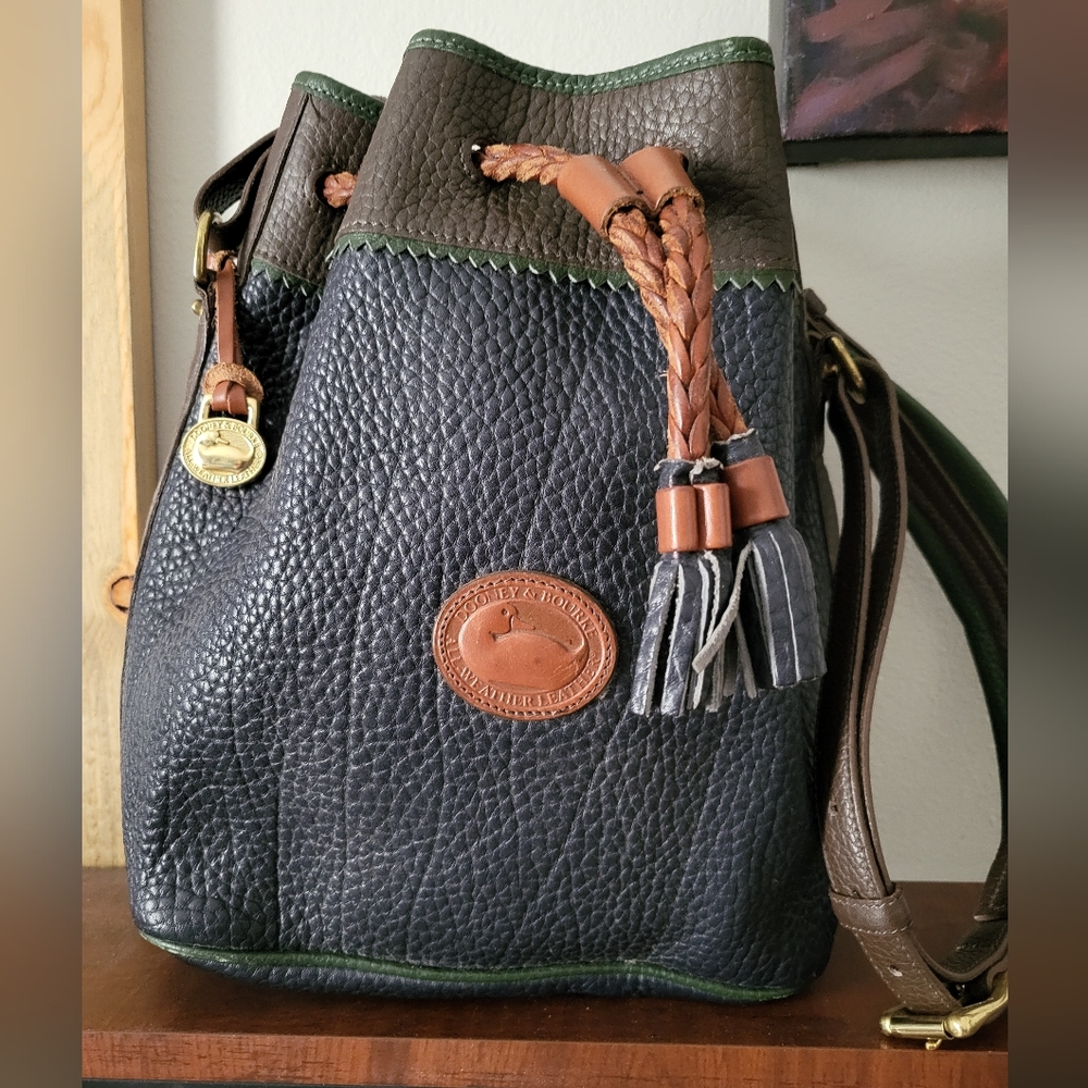 Vintage Dooney & Bourke Leather Drawstring Bucket Bag in Navy, Green, And Brown.